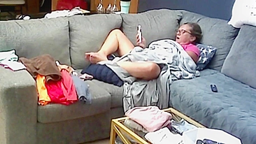 Mãe de óculos acha que não vai ser pega se masturbando debaixo do cobertor